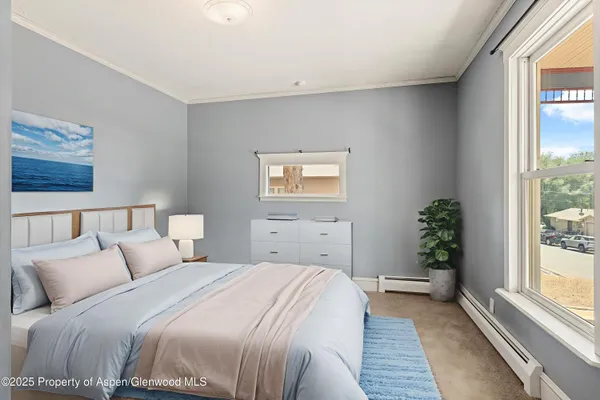 a bedroom with a large bed and a window