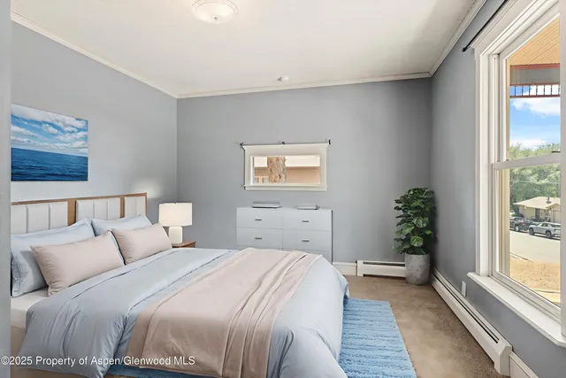 a bedroom with a large bed and a window