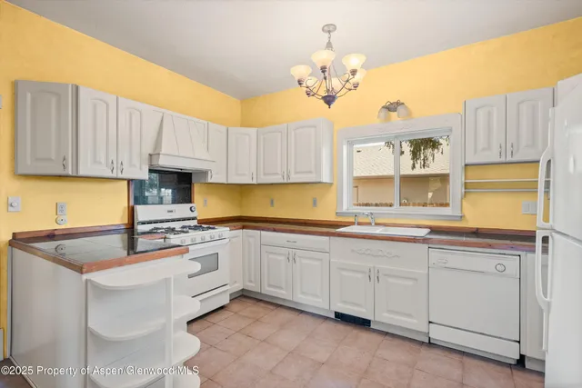 a kitchen with cabinets appliances and a sink