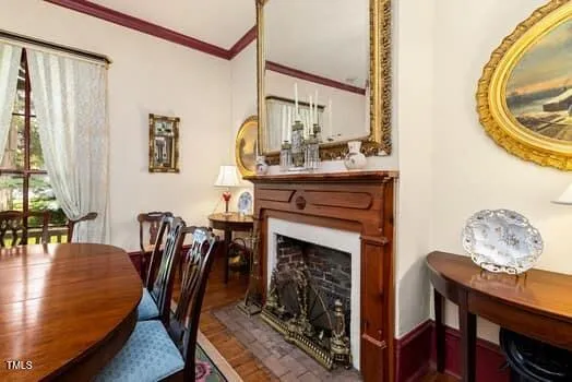 a view of a a dining room with furniture window and wooden floor