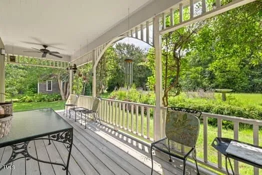 a living room with furniture a flat screen tv and kitchen view
