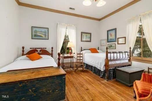 a view of a house with backyard and wooden fence