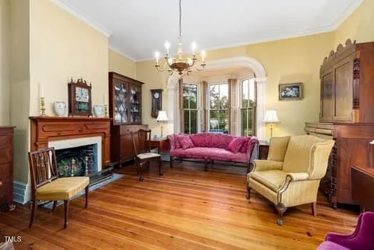 a living room with furniture and a chandelier