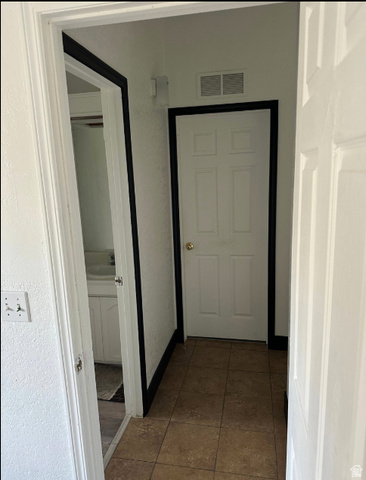 265 Mindella Way Layton, UT 84041 - Photo 16 of 32 Tiled entryway with paneled doors and white walls