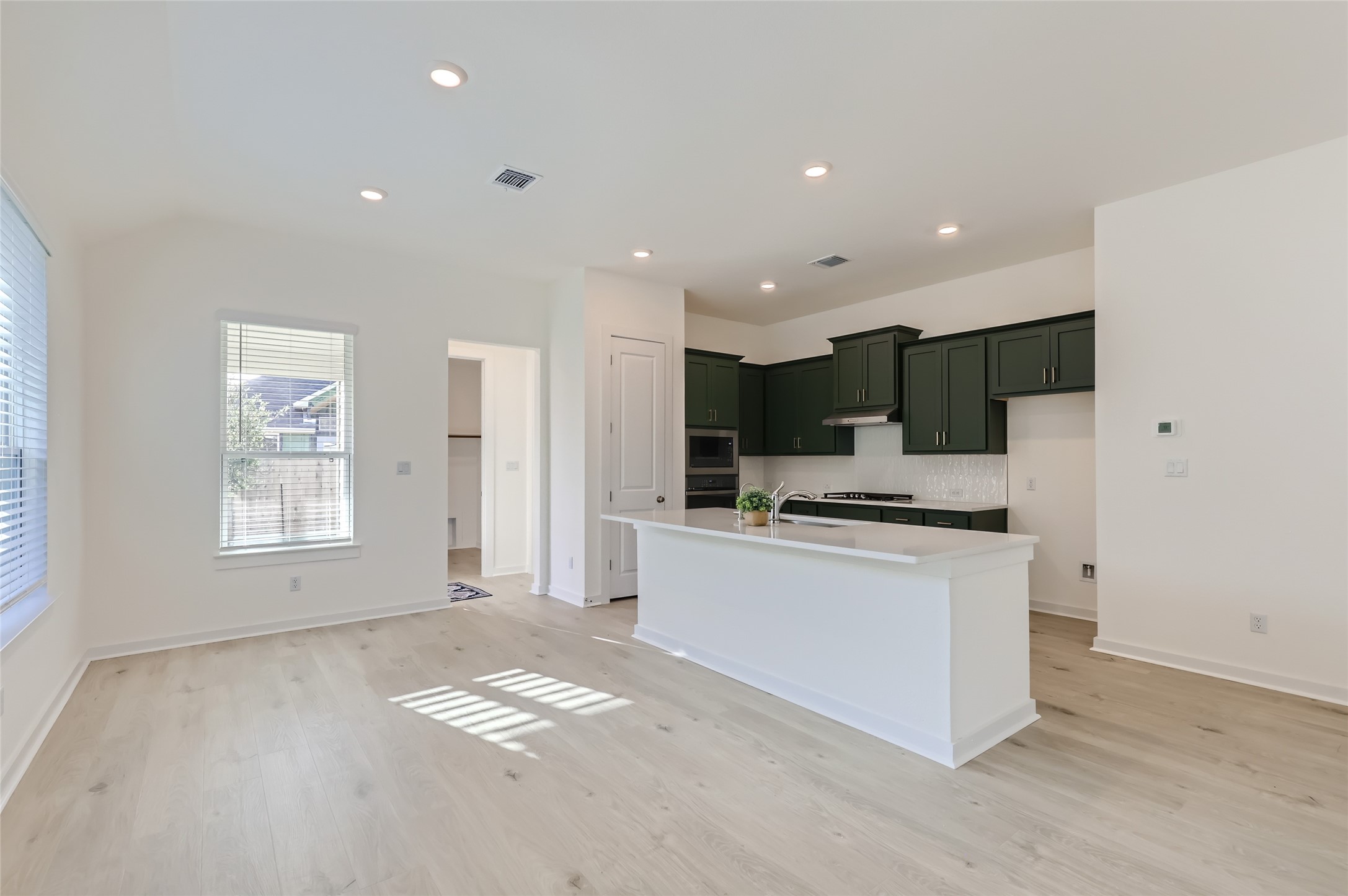 100 Cherry Sage Cove Georgetown, TX 78628 - Photo 5 of 14 a kitchen with stainless steel appliances kitchen island sink refrigerator and cabinets