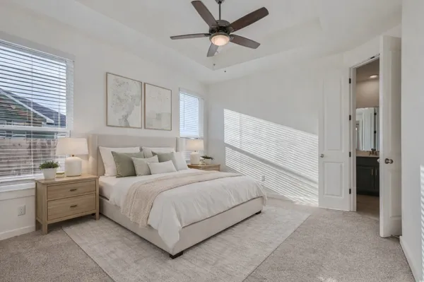 a bedroom with a bed and a ceiling fan