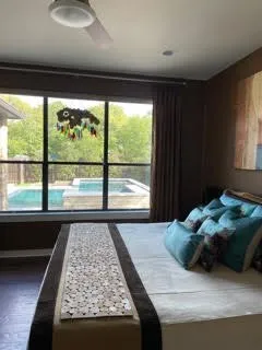 a bed sitting in a bedroom next to a large window