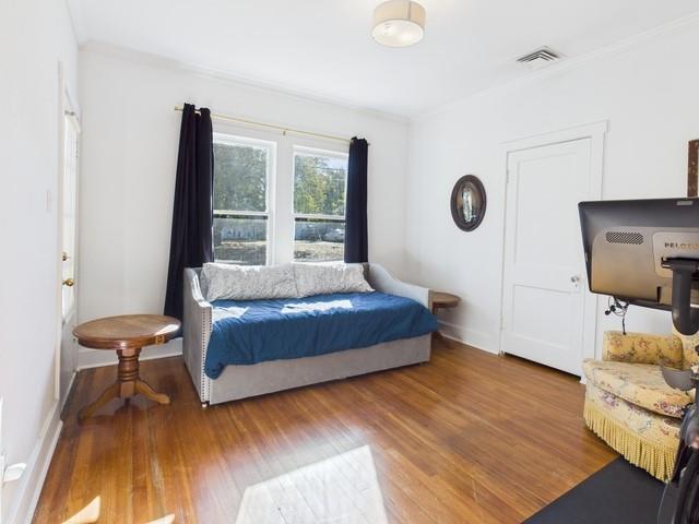 226 South Pinkerton Street Athens, TX 75751 - Photo 17 of 35 a spacious bedroom with a bed and a dresser next to a window