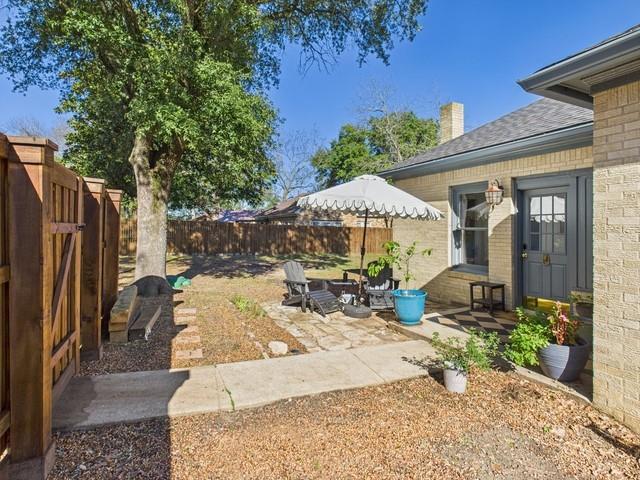 226 South Pinkerton Street Athens, TX 75751 - Photo 24 of 35 a view of a patio with table and chairs under an umbrella with large trees