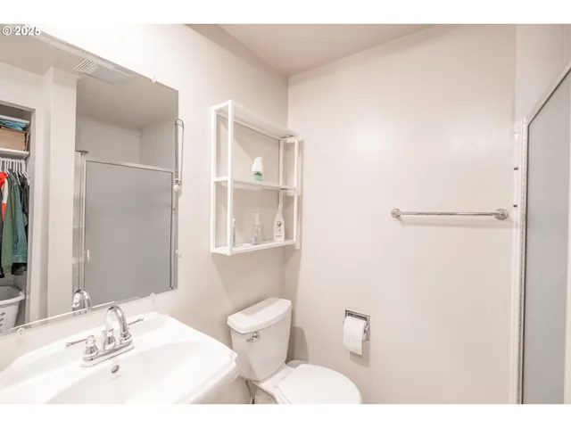 a bed room with a bed and a ceiling fan