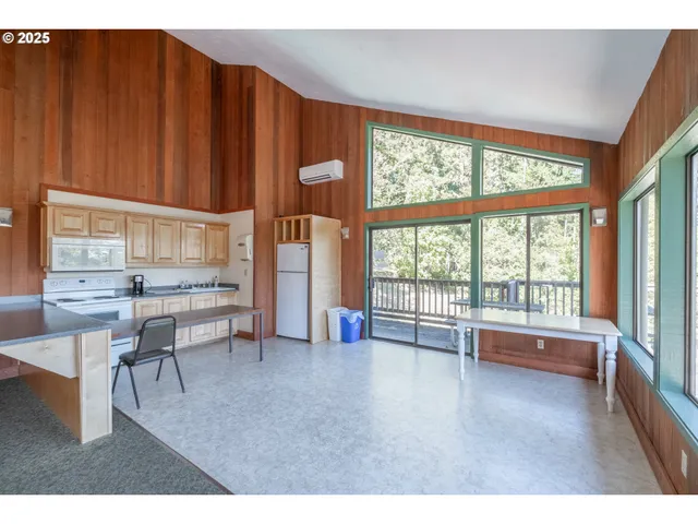 a view of a tennis ground with a table and chairs