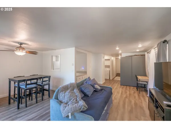 a living room with furniture a dining table and a flat screen tv