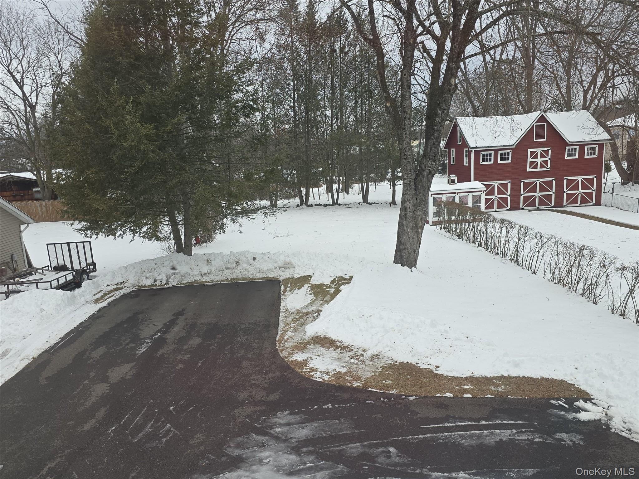 59 Bridge Street, Unit 2 Wallkill, NY 12589 - Photo 14 of 14 Yard covered in snow with a barn