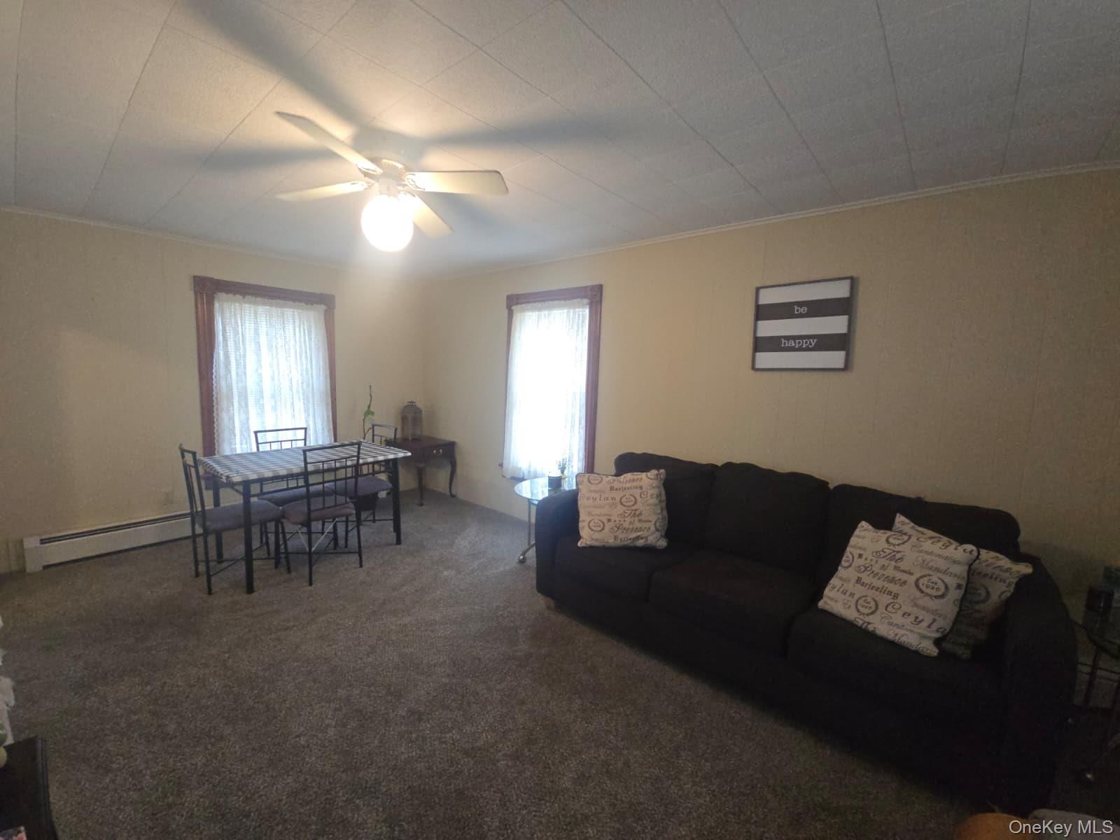 59 Bridge Street, Unit 2 Wallkill, NY 12589 - Photo 7 of 14 Living room with ornamental molding, carpet flooring, and ceiling fan