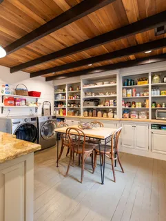a dining room with furniture a chandelier and wooden floor