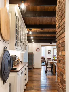 a dining room with furniture and wooden floor