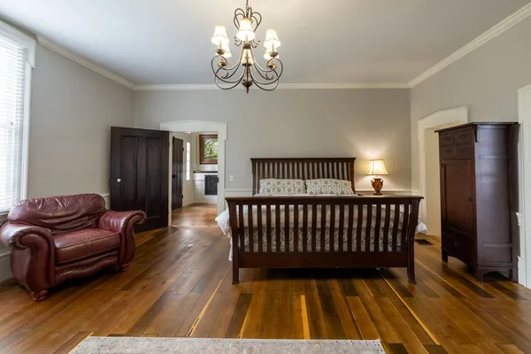 a spacious bedroom with a large bed and a large window