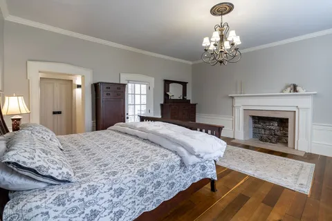 a bedroom with a bed a window and dresser