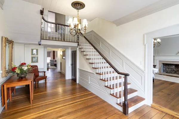 a view of a livingroom with furniture cabinet and chandelier