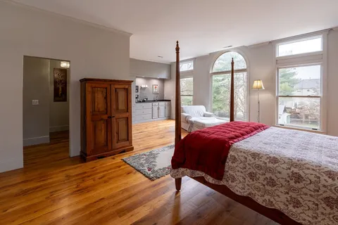 a bathroom with a granite countertop toilet and a sink
