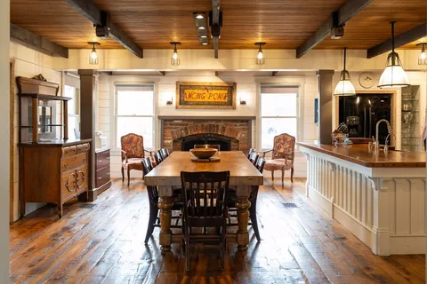 a dining table with chairs and wooden floor