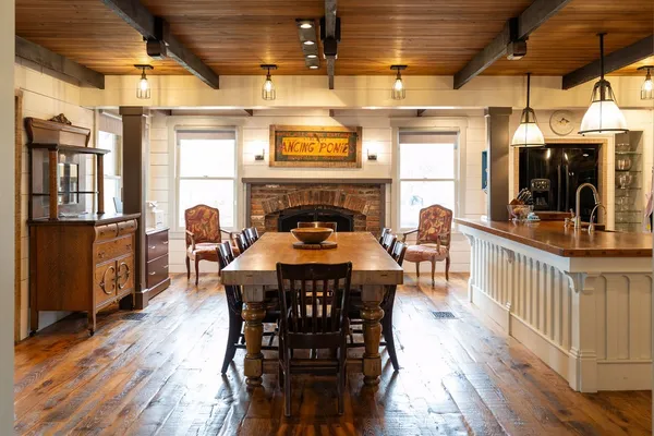 a dining table with chairs and wooden floor