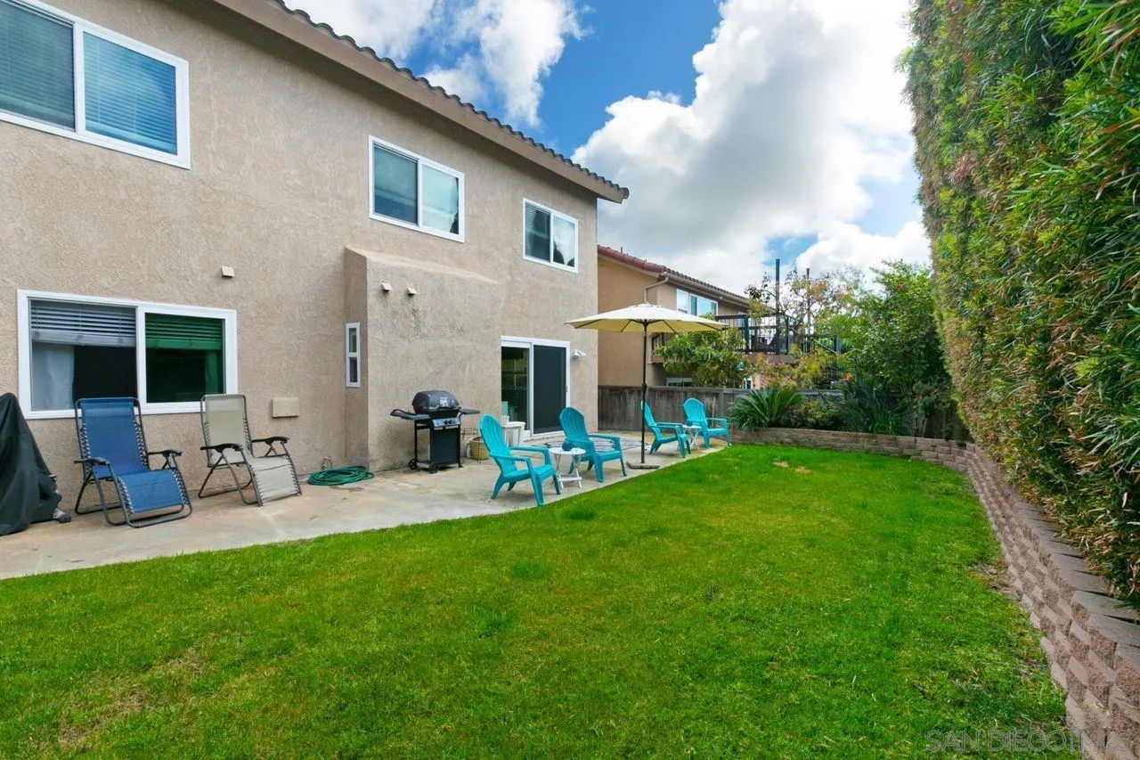 946 Alyssum Road Carlsbad, CA 92011 - Photo 19 of 19 a view of a house with backyard sitting area and garden