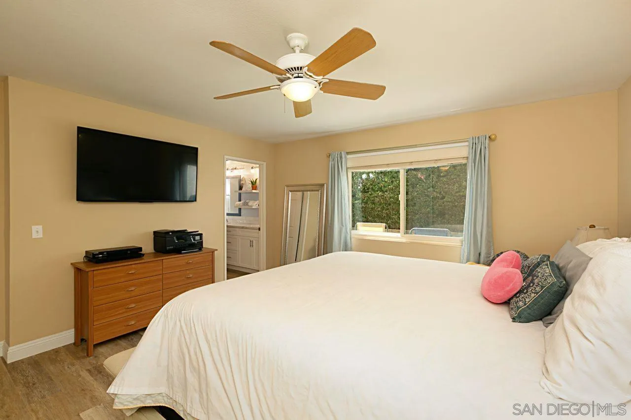 946 Alyssum Road Carlsbad, CA 92011 - Photo 10 of 19 a bedroom with a bed and a flat screen tv