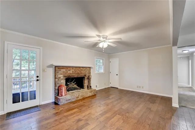 wooden floor in an empty room with a fireplace