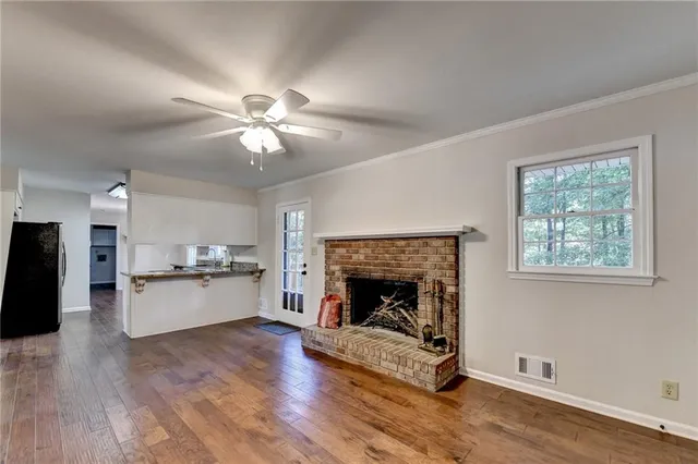 a kitchen with granite countertop white cabinets and window