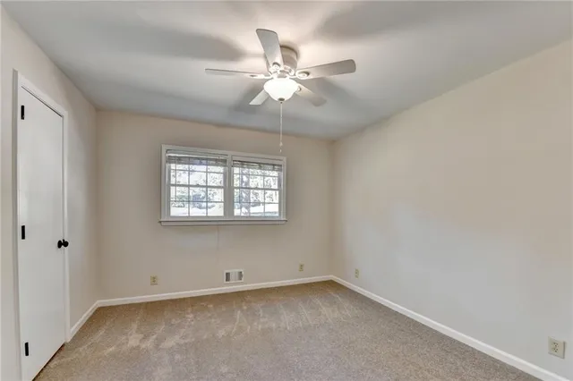 a bathroom with a granite countertop sink a toilet and shower
