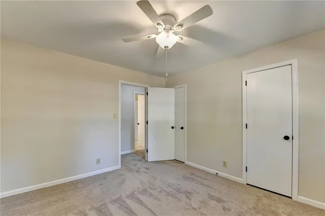 an empty room with windows and cabinet