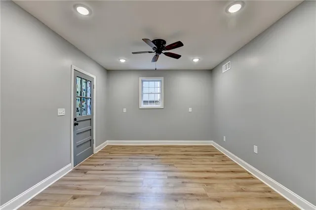a view of a grassy field with trees in the background