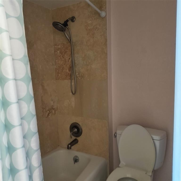 1200 Hibiscus Avenue, Unit 903 Pompano Beach, FL 33062 - Photo 13 of 20 a bathroom with a toilet and shower
