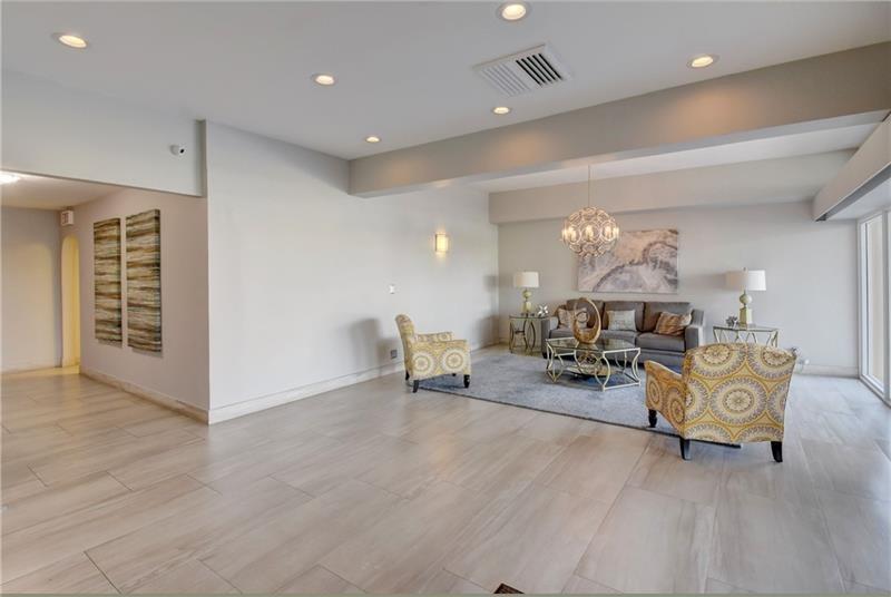 1200 Hibiscus Avenue, Unit 903 Pompano Beach, FL 33062 - Photo 18 of 20 a living room with furniture and a table