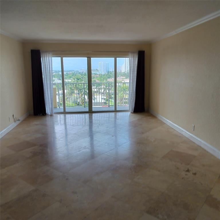 1200 Hibiscus Avenue, Unit 903 Pompano Beach, FL 33062 - Photo 5 of 20 a view of an empty room with wooden floor and a window