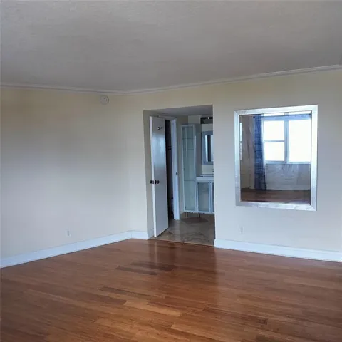 a view of wooden floor and windows in a room