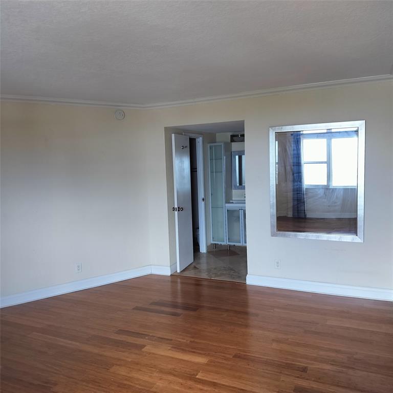 1200 Hibiscus Avenue, Unit 903 Pompano Beach, FL 33062 - Photo 7 of 20 a view of wooden floor and windows in a room