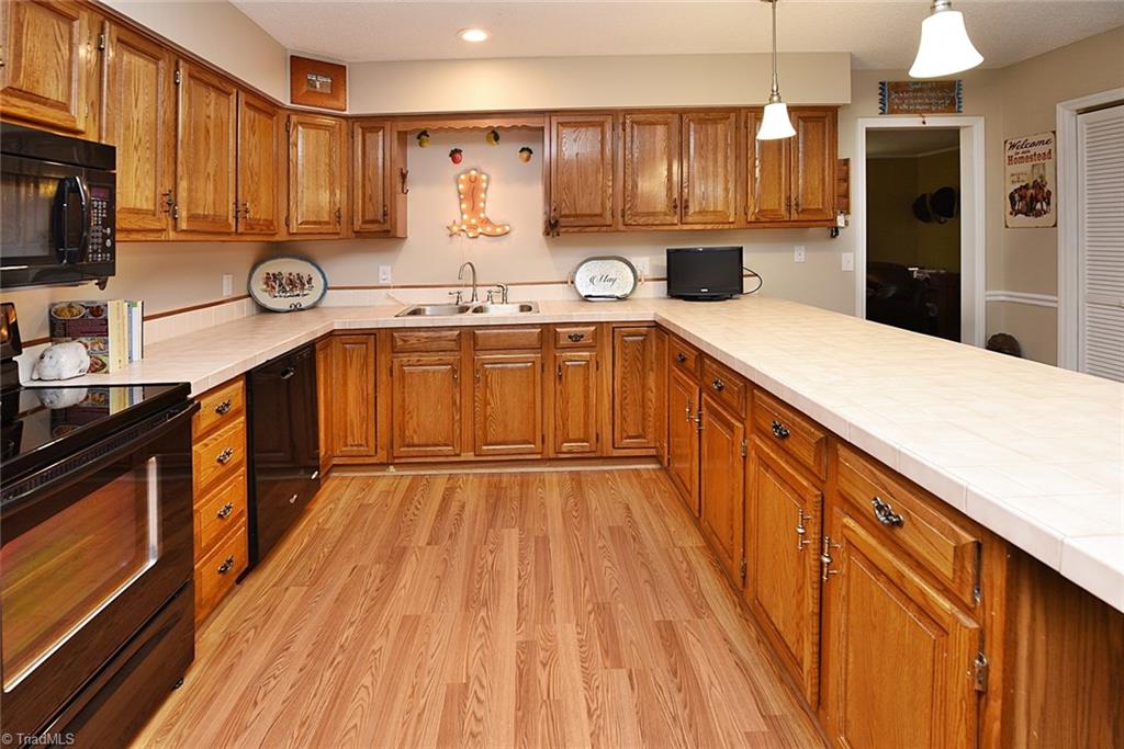 1191 Pullman Drive Rural Hall, NC 27045 - Photo 9 of 23 view of lots of cabinets and kitchen w/hardwoods