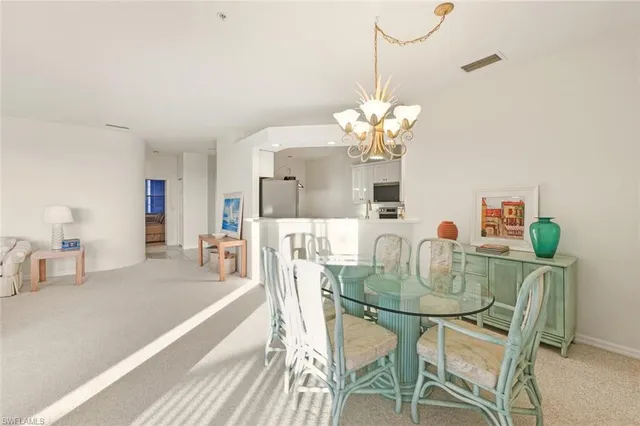 a dining room with furniture and chandelier