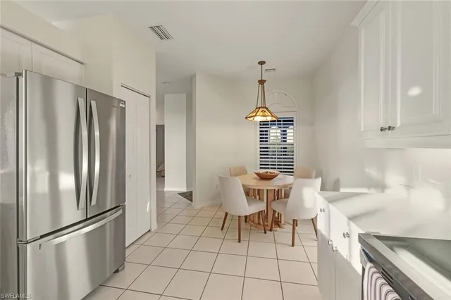 a kitchen with stainless steel appliances a refrigerator and a stove top oven