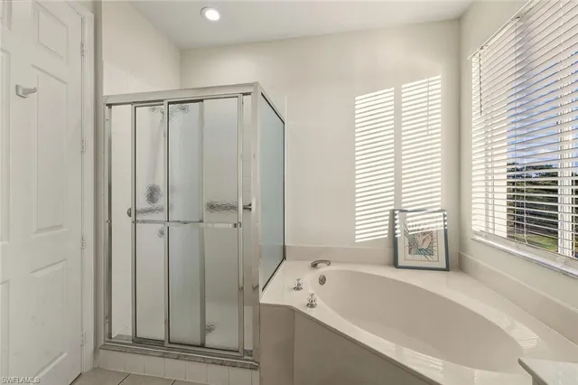 a bathroom with a bathtub and a shower