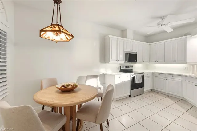 a kitchen with a sink chairs and microwave