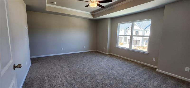 1476 Fern Ridge Lane Norcross, GA 30093 - Photo 11 of 19 an empty room with windows and ceiling fan