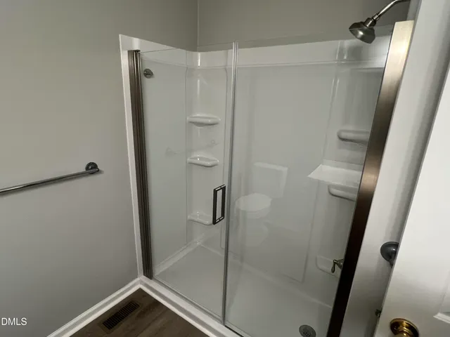 a bathroom with a glass shower door