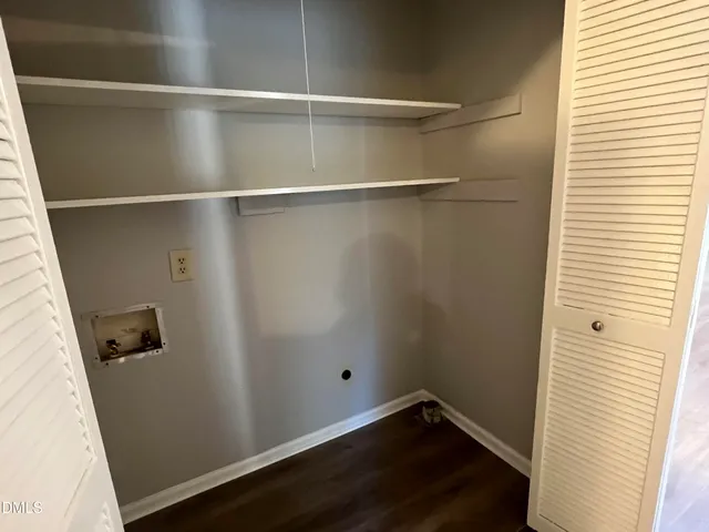 a view of a room with wooden floor