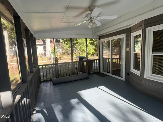 a view of an entryway with wooden floor and door