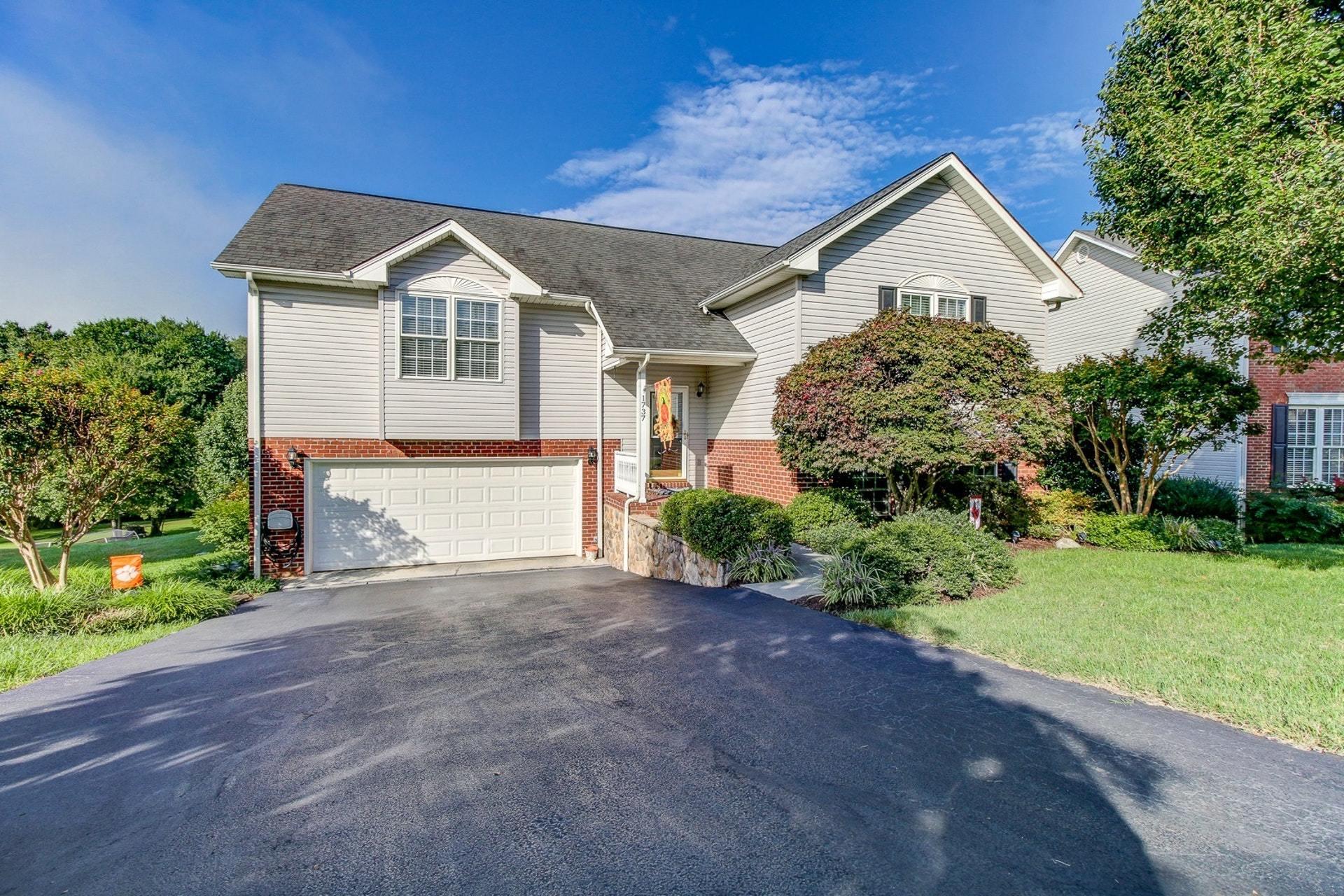 1737 Meadows Road Vinton, VA 24179 - Photo 2 of 37 a front view of a house with a yard and garage