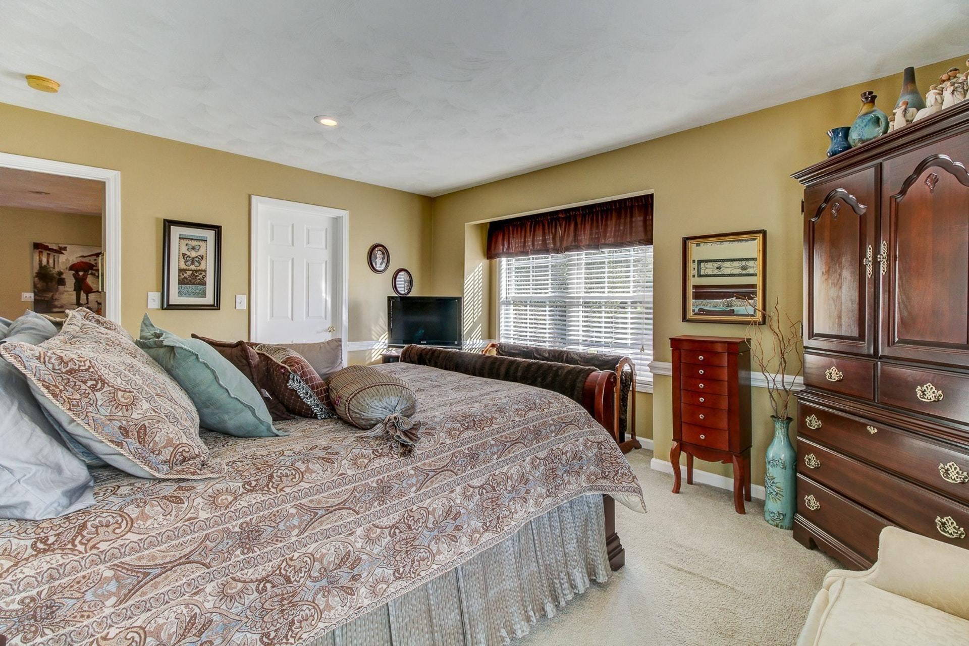 1737 Meadows Road Vinton, VA 24179 - Photo 13 of 37 a bedroom with a bed and dresser with mirror
