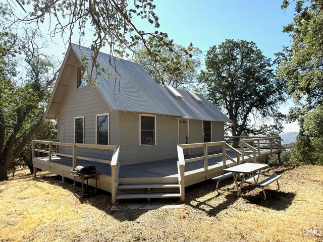 a view of a house with a wooden fence